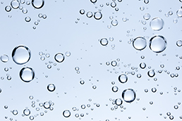 Gas bubbles in a liquid to illustrate the OPTIMASS 6400 synthetic drive control feature